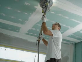Construction worker polishing ceiling inside a home in Chennai