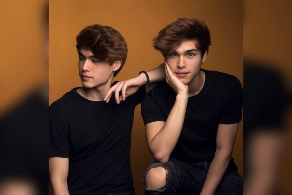 Alan and Alex Stokes, known as the Stokes Twins, posing for a professional portrait. The identical twin YouTubers stand at 6'2" (1.88 m), making them slightly taller than MrBeast.