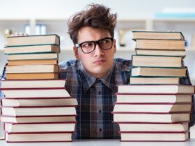 Student with different books representing exam preparation load