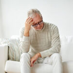 Caregiver supporting a happy senior at home