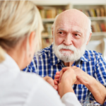 Compassionate nurse comforting an elderly dementia patient.