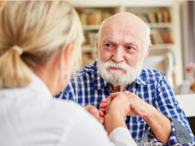 Compassionate nurse comforting an elderly dementia patient.