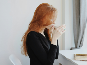 Woman practicing self-care while sitting indoors and relaxing